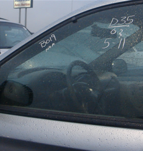 Auction and car information written on a car’s window