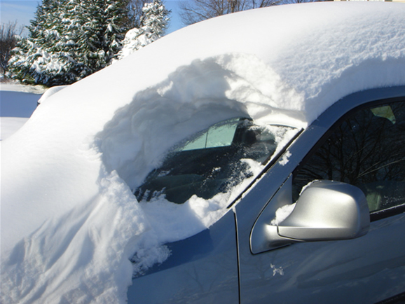 A car covered with at least a foot of snow